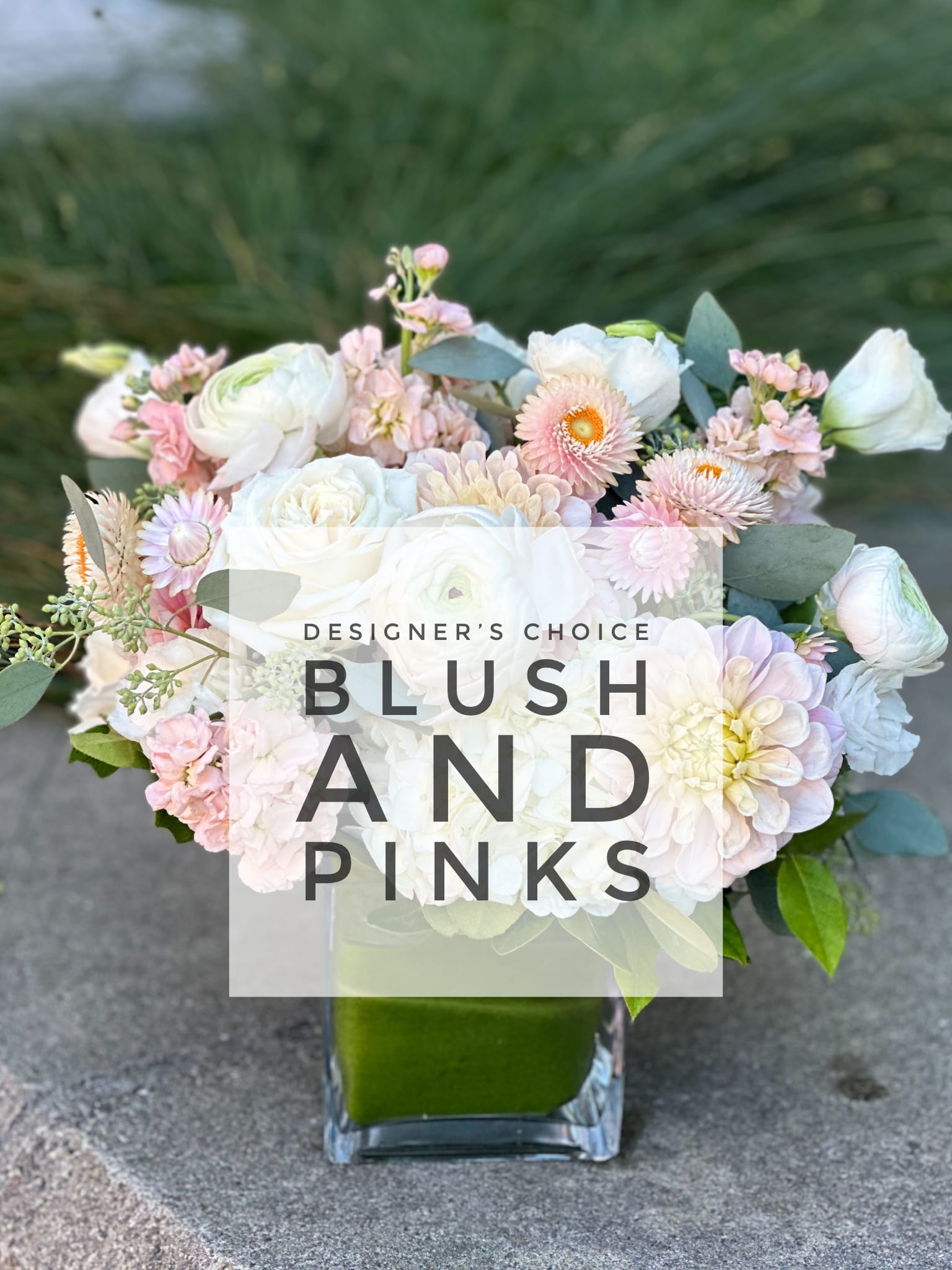 Blush and white mixed bouquet in a square glass vase
