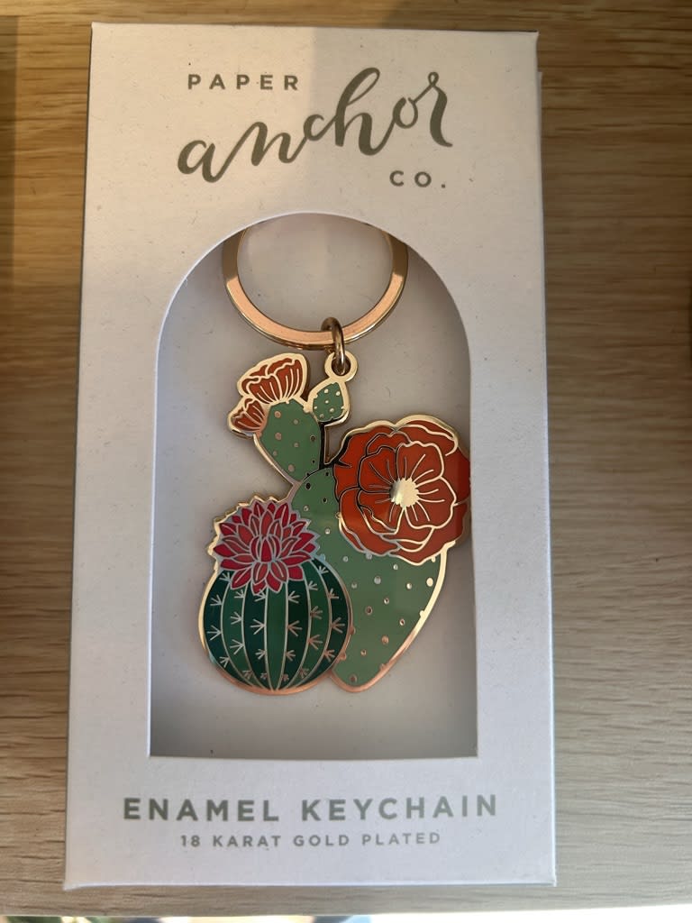 Enamel cactus keychain in a retail box
