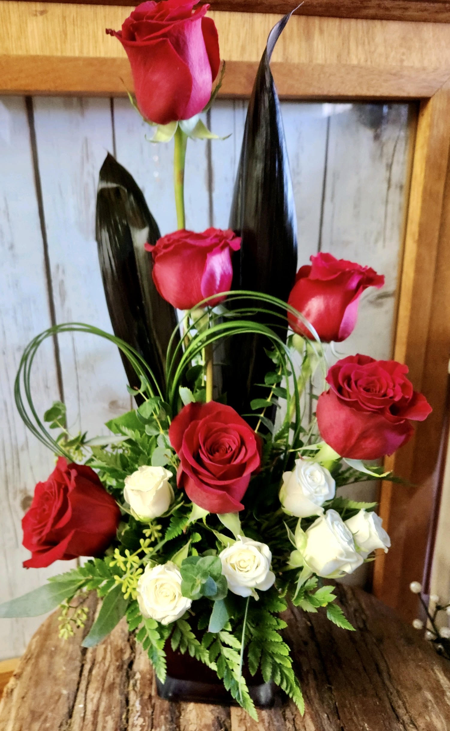 Red and White Delight - Lush red roses arranged with lovely white spray roses arranged in a cube. Perfect size for a desk or small table.