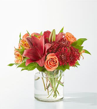 Saffron Mist Arrangement - Capturing the vibrant colors of autumn foliage, this eye-catching arrangement is an exuberant mix of deep reds and warm oranges.