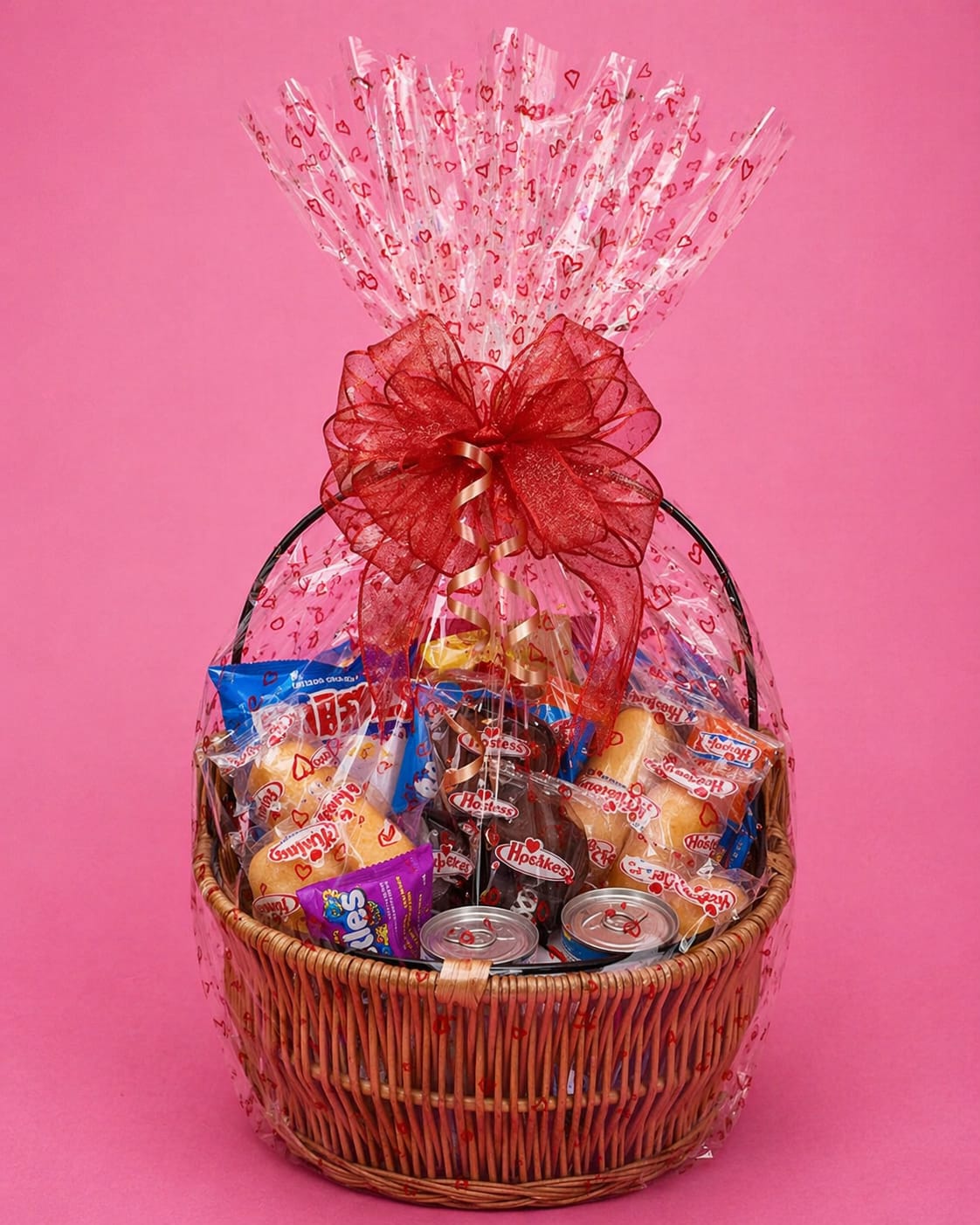 Junk Food Basket - The perfect gift for your junk food lovers! A mix of sweet and salty goodies including chips, drinks, and sweet treats in a wicker basket wrapped in cellophane with a bow to bring it all together. 