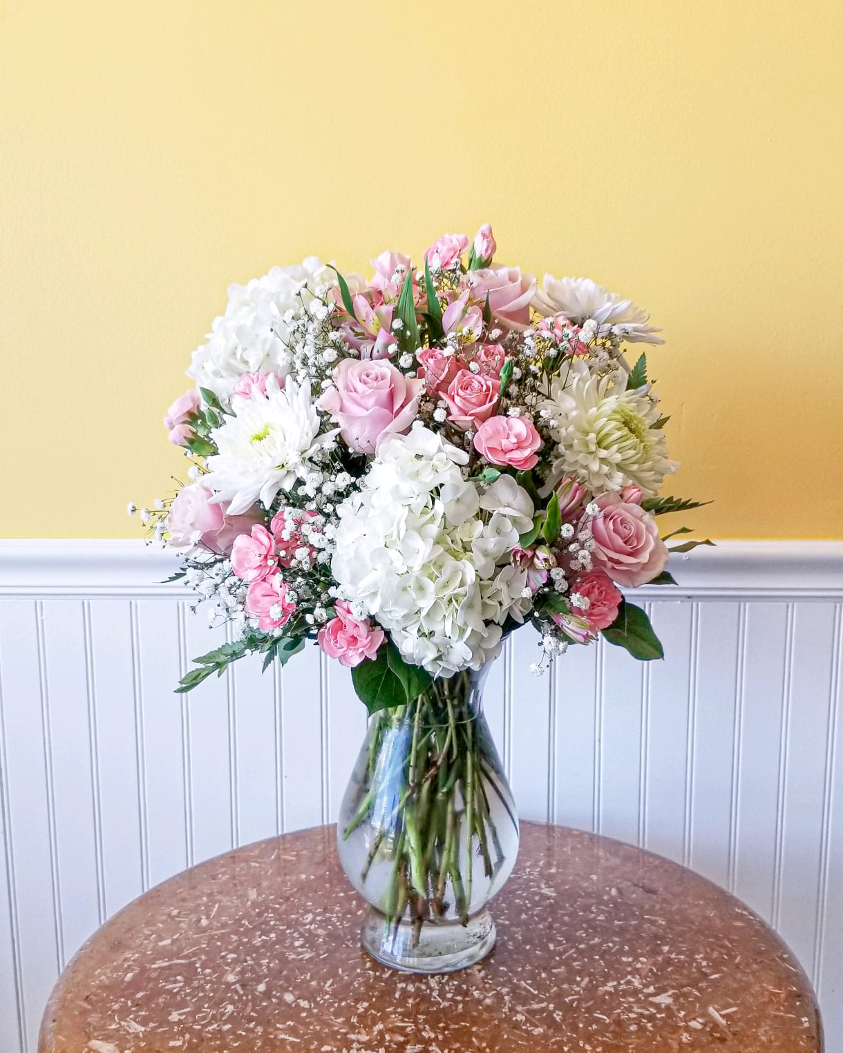 Pink and white mixed flower bouquet in a clear glass vase