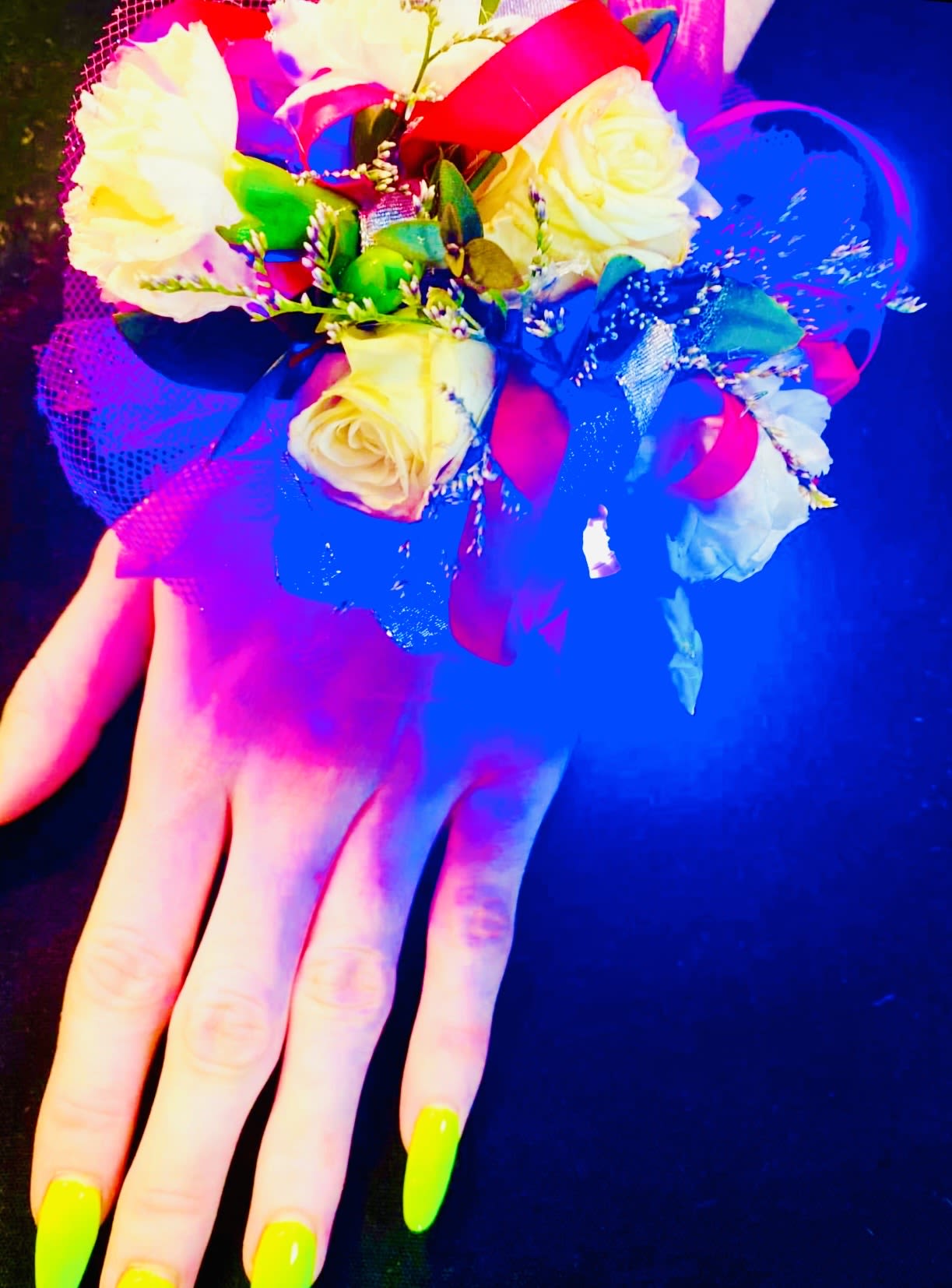 Electric Elegance  - A stunning light-up corsage designed to make a statement, featuring beautifully arranged blooms enhanced with a soft, radiant glow. Tiny встроенные LED lights are delicately woven throughout the flowers, creating a gentle illumination that highlights each petal and detail. Whether in low light or on the dance floor, the corsage emits a magical shimmer that captures attention without overpowering its elegance. Finished with coordinating ribbons and a comfortable wristband, this piece blends modern flair with timeless beauty—perfect for proms, weddings, or any event where you want to truly shine