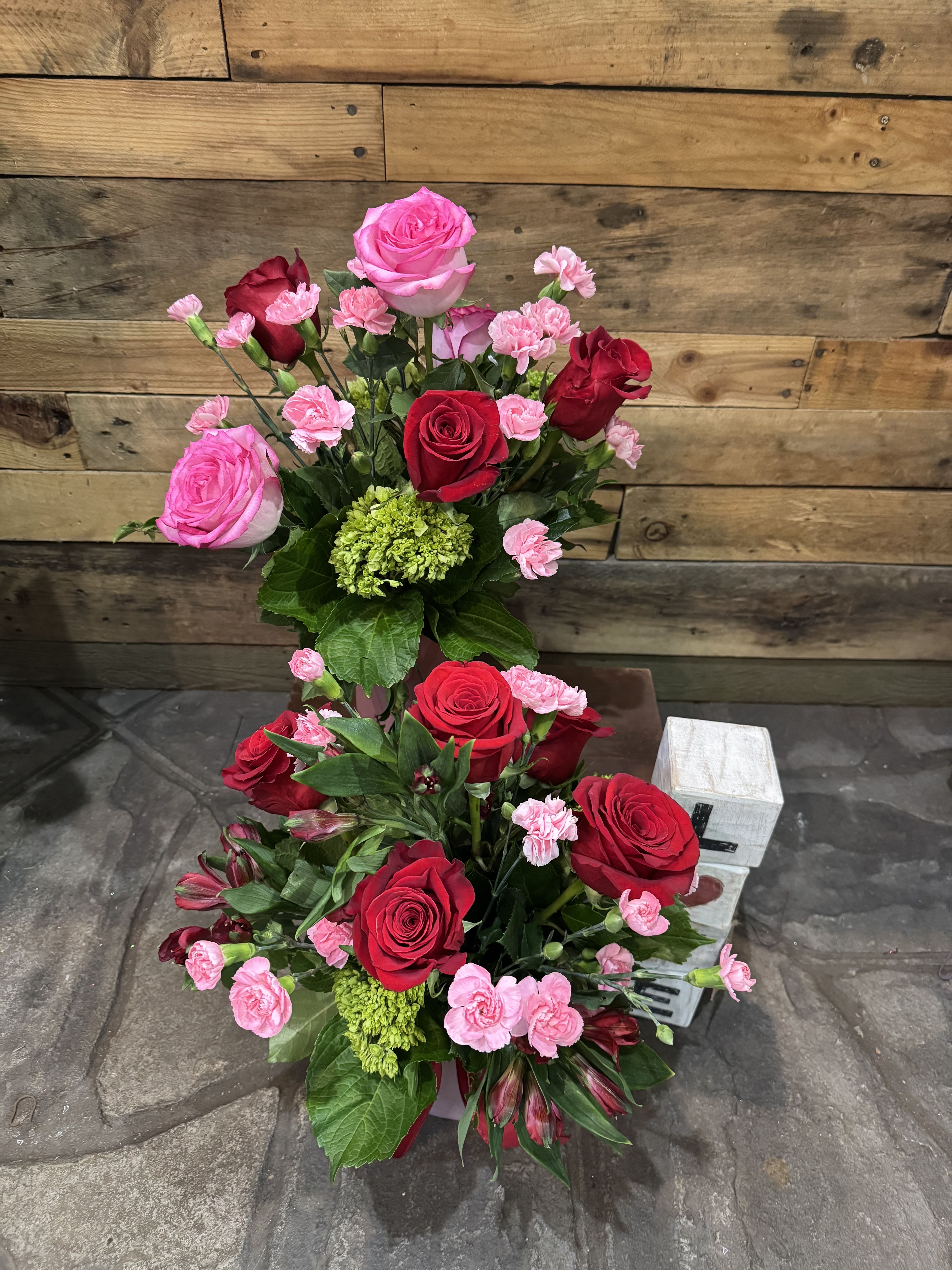 Mothers day Special - Pretty light pink vase with beautiful Ecuadorian red roses and mini carnations.