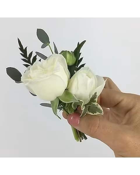 White + Green Boutonniere - All of our boutonnieres include multiple blooms with touches of greenery. Each boutonniere is wrapped in a thin tie of silk ribbon and two boutonniere pins are included.