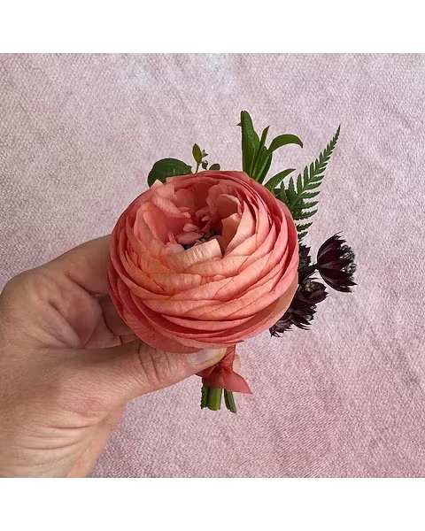 Plum + Peach Boutonniere - All of our boutonnieres include multiple blooms with touches of greenery. Each boutonniere is wrapped in a thin tie of silk ribbon and two boutonniere pins are included.