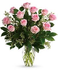 Pink roses arranged in a clear glass vase