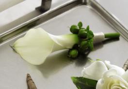 White calla lily boutonniere with green berries