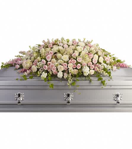 Always Adored Casket Spray - A beautiful spray of soft pink white and cr?me blooms ease the burden of loss. Pink hydrangea larkspur and roses mingle with white roses stock and waxflower. Ivy fern and fragrant eucalyptus act as green accents in this spray that rests atop the casket.Approximately 66" W x 28" H Orientation: N/A As Shown : T236-3A
