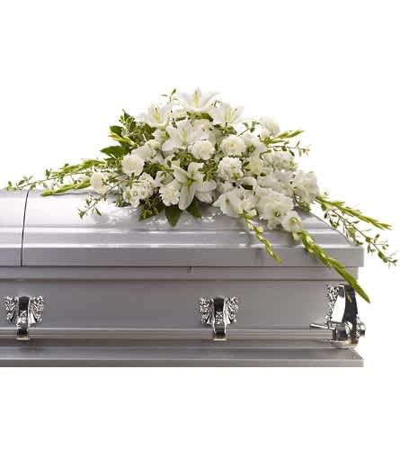 Bountiful Memories Casket Spray - A casket spray made of all white flowers and simple greenery is a simply stunning way to honor the deceased while bringing a quiet strength and serenity to those present. Gorgeous white oriental lilies gladioli carnations and more create a beautiful crescent shaped casket spray.Approximately 49" W x 27" H Orientation: N/A As Shown : T242-4A