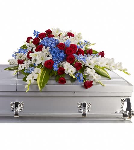 Distinguished Service Casket Spray - A beautifully patriotic way to pay tribute to a loved one. This half-couch spray sends an eloquent message of strength respect and freedom. Brilliant flowers such as blue hydrangea red roses white oriental lilies and much more create this dignified way to honor the deceased.Approximately 46 1/2" W x 24" H Orientation: N/A As Shown : T240-3A