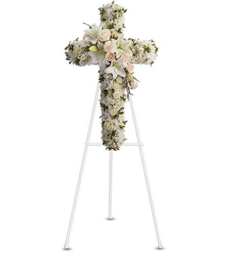 Divine Light - Your message of hope for eternal serenity is delivered ever so elegantly in this graceful cross. Your sincerity will be acknowledged by all who are present. Cr?me roses white spray roses oriental lilies stock leptosporum cushion and button spray chrysanthemums create a cross that is a beautiful way to honor a loved one.Approximately 22 1/2" W x 36" H Orientation: One-Sided As Shown : T232-2A