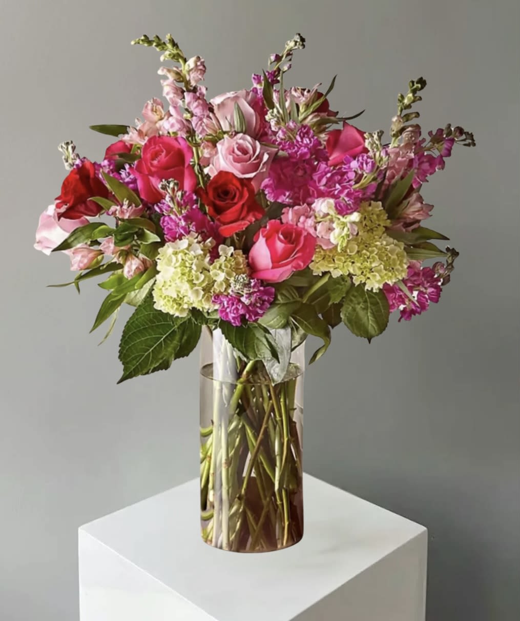 Pink and red rose bouquet in a clear glass vase