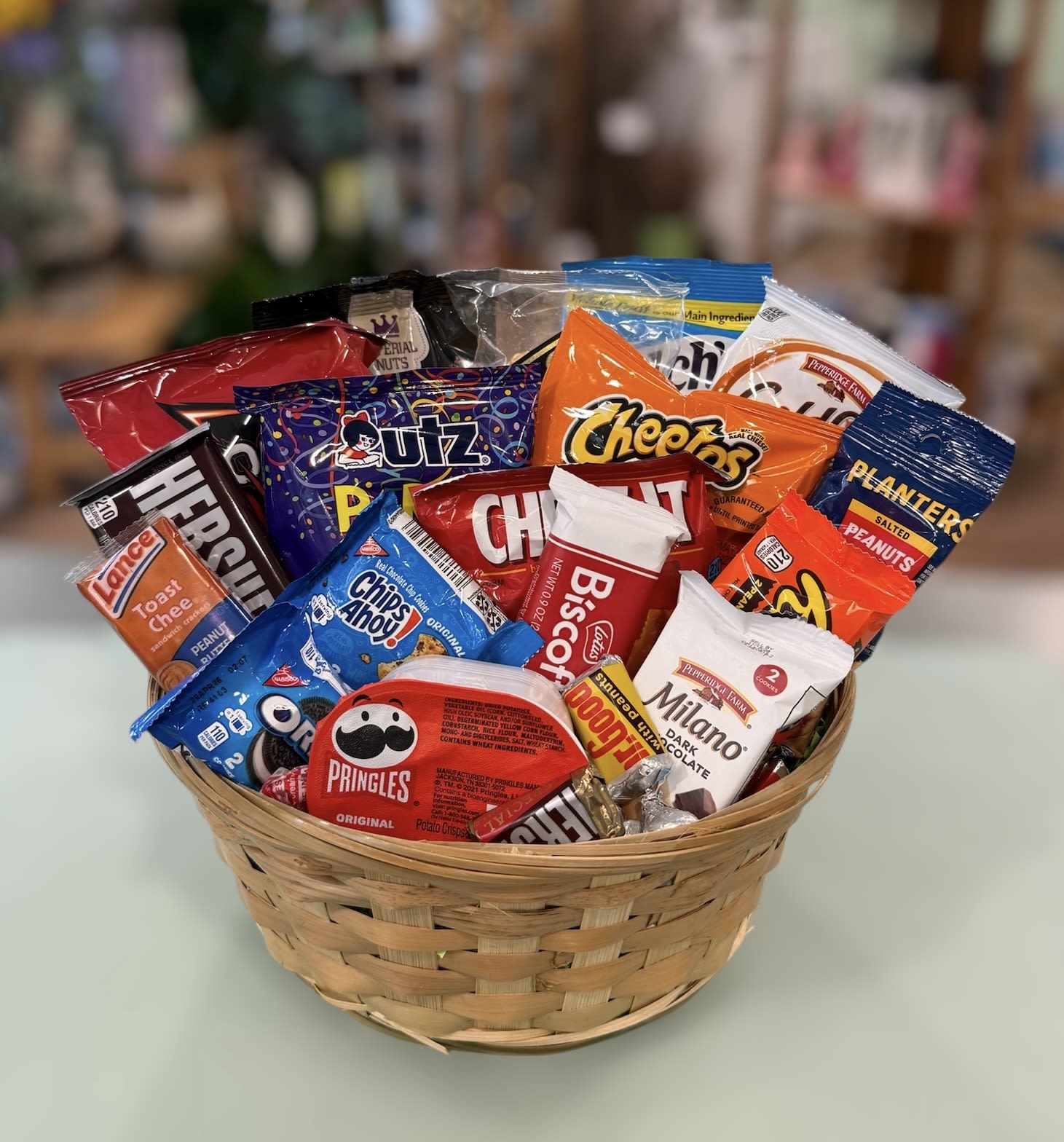 The Snackin' Basket (SNB) - When you you want to send something sweet such as chocolate and snacks, we have it all together for you.  Cookies, chocolate bars, candy and more fill this basket of treats.