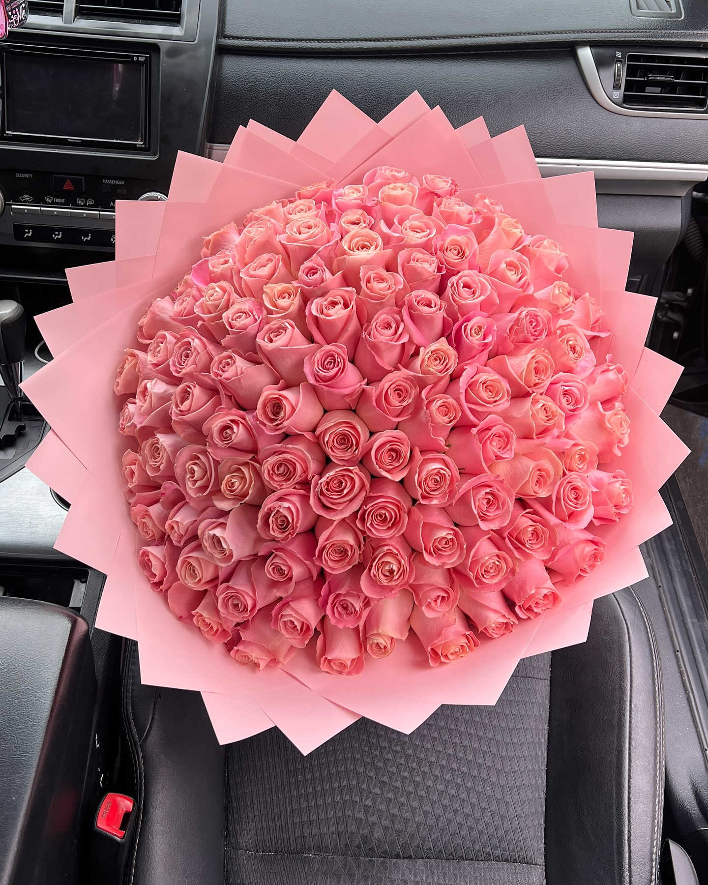 Large bouquet of pink roses wrapped in pink paper