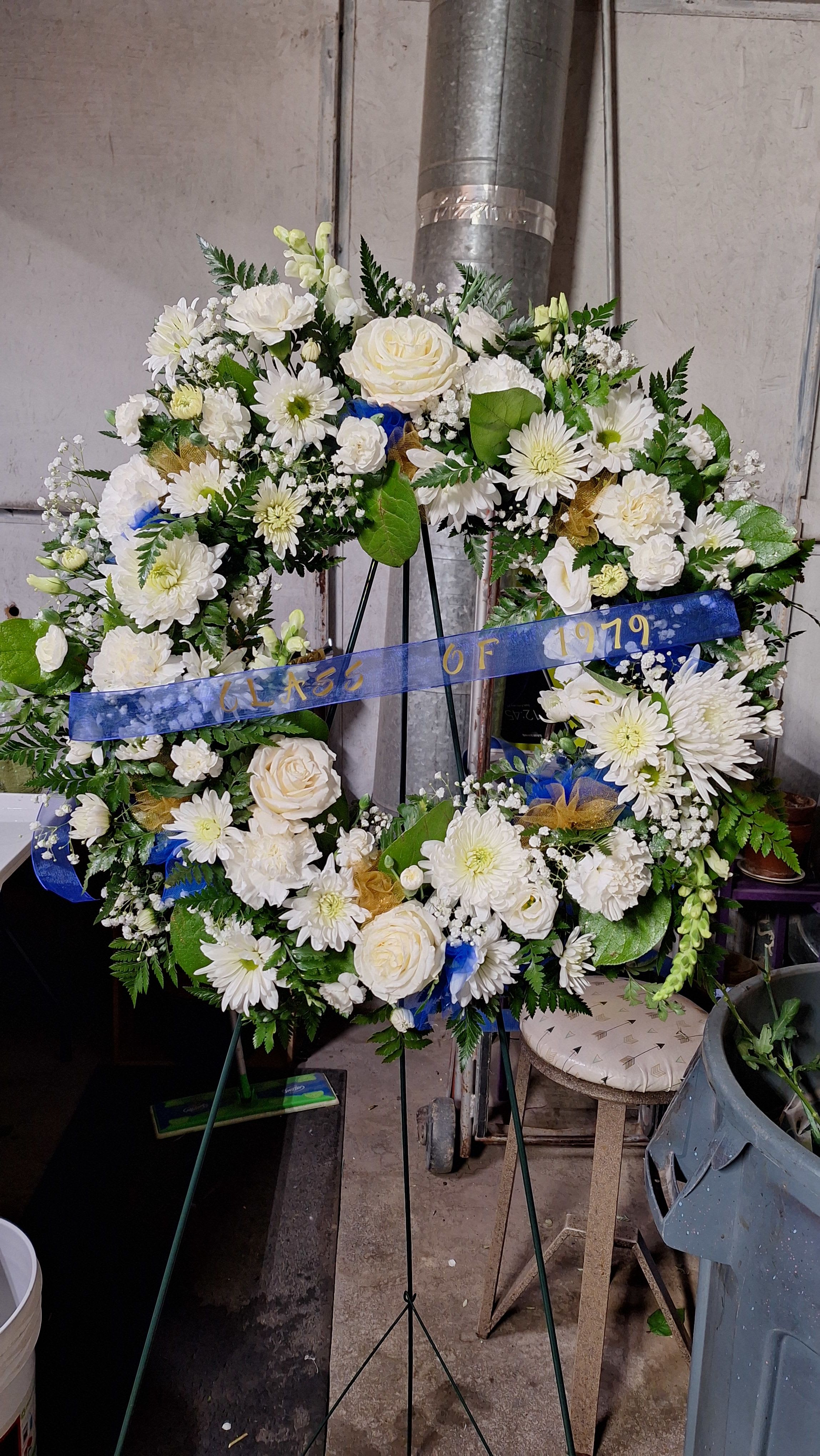 Warm Thoughts Wreath - A bright standing wreath of greenery and fresh flowers in white will send a message of hope and harmony, and help to celebrate a meaningful life.