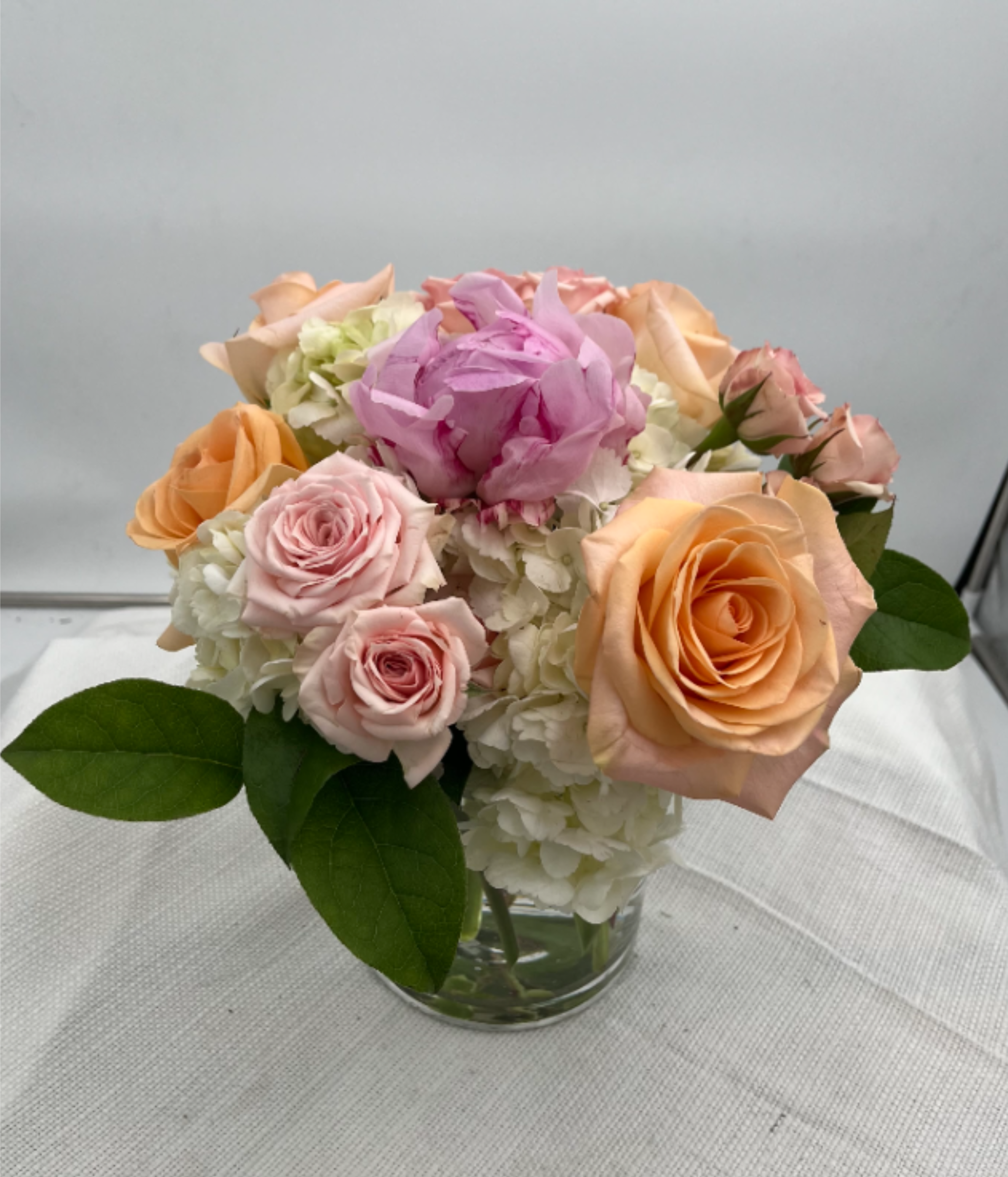 Perfect Peony - Hydrangea, roses, spray roses and one peony make up this charming minimalist arrangement.