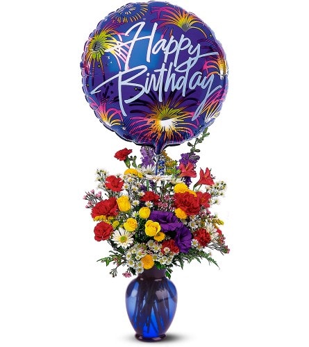 Birthday balloon above a colorful mixed flower arrangement in a blue vase