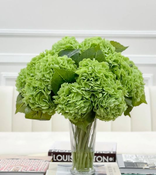 Green hydrangea bouquet in a clear glass vase