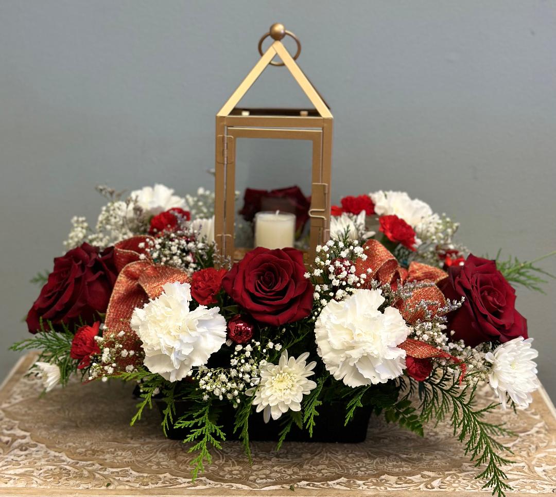 Red and white floral arrangement with a lantern centerpiece