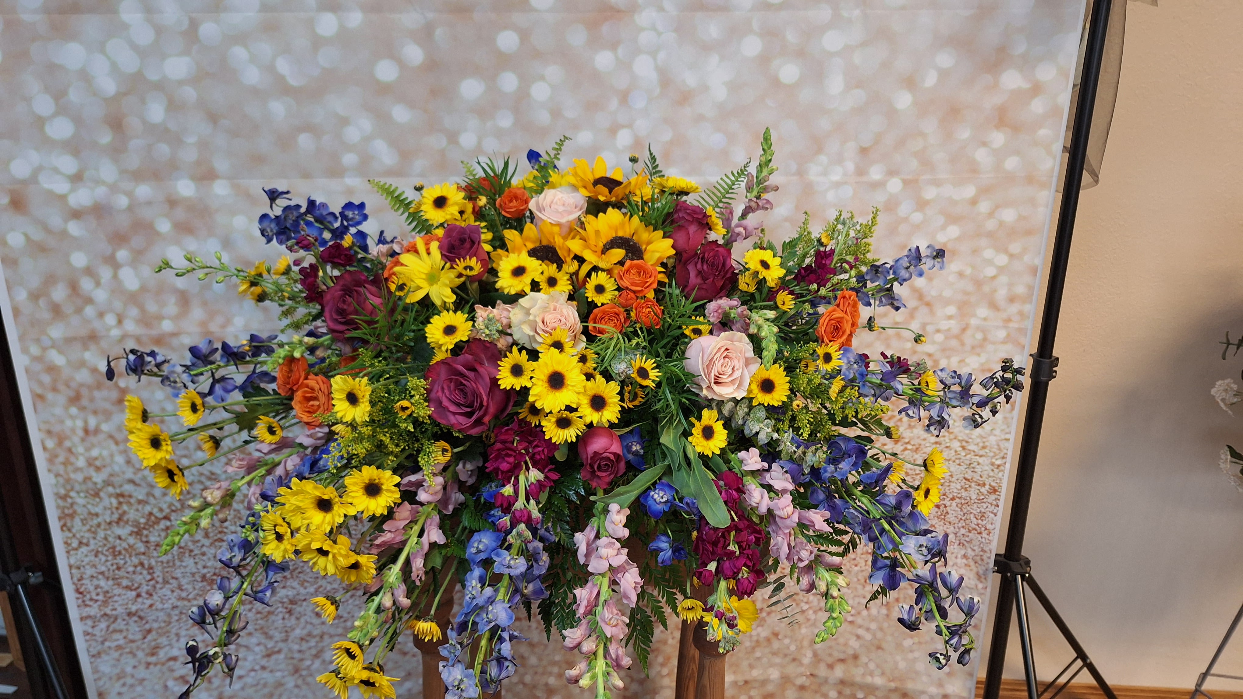 Colorful Memories Casket Spray - A time-honored tribute, this cascading blaze of color celebrates your love one's life in a most uplifting way.