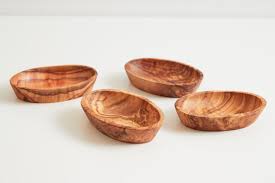 Four small wooden bowls on a white background