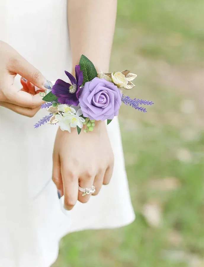bold purple  Color Boutonnière (Modern &amp; Stylish - A romantic lavender wrist corsage designed for weddings and proms makes the person you're celebrating feel effortlessly elegant from the first handshake to the last dance. This wrist corsage for bridal parties and formal events features a large lavender rose-like bloom as the focal point, accented by a deep purple flower and tiny white blossoms that create a soft, feminine palette perfect for bridesmaids, mothers of the bride, or prom dates.  Made from high-quality silk petals and greenery, the compact arrangement includes slender purple sprigs that give the piece a light, airy silhouette while keeping the overall look polished and wearable. The durable silk construction means the corsage stays fresh-looking through pictures and all-night celebrations without wilting or crushing.  Ideal for matching purple, white, or green color schemes, this wrist corsage is the kind of finishing touch that makes someone feel truly seen on their special day. It arrives ready to wear with a comfortable wristband-choose it for weddings, proms, or any formal occasion when you want her to feel cherished and camera-ready.