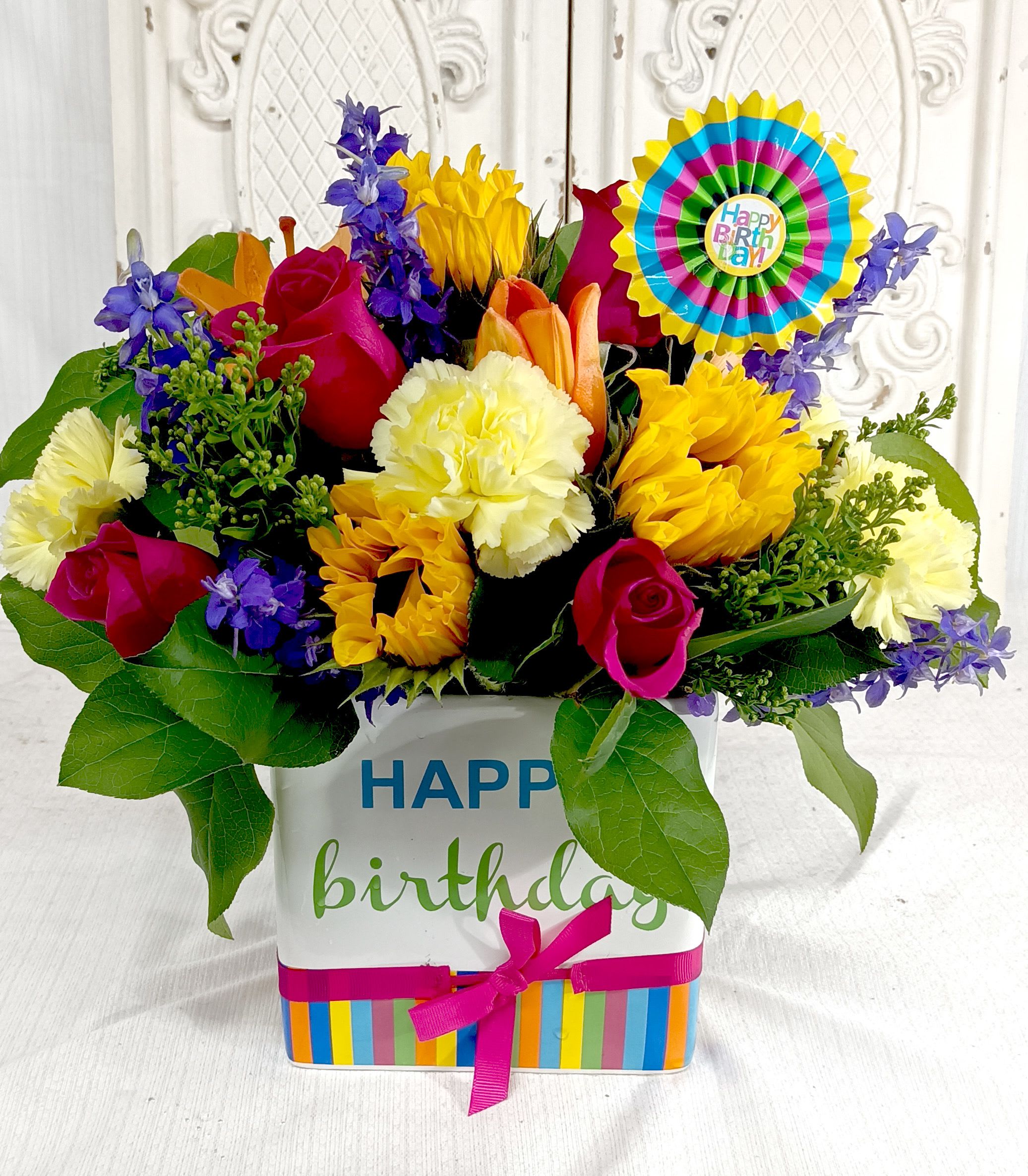 Colorful birthday flower arrangement in a decorated gift box