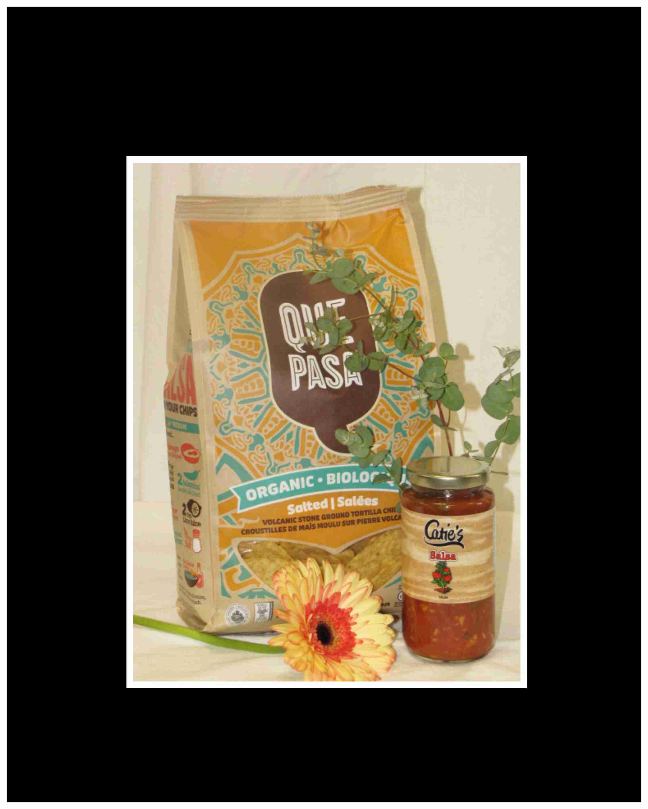 Snack bag, salsa jar, and a gerbera daisy with eucalyptus sprigs