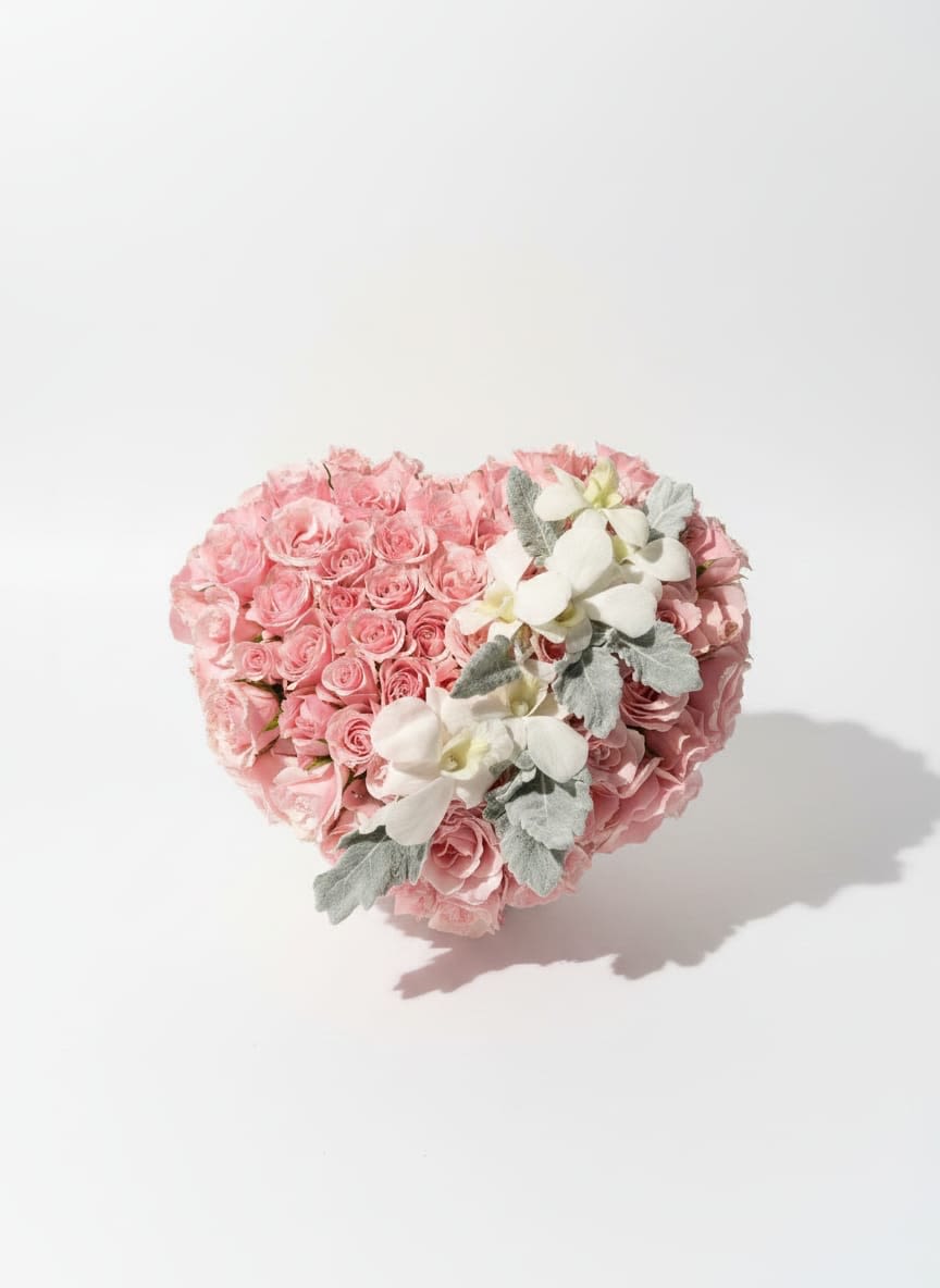 Heart-shaped bouquet of pink roses with white orchids