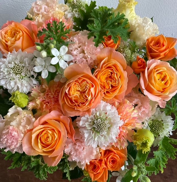 orange juice - this is a beautiful, passionate, artful arrangement arranged in a low vase 