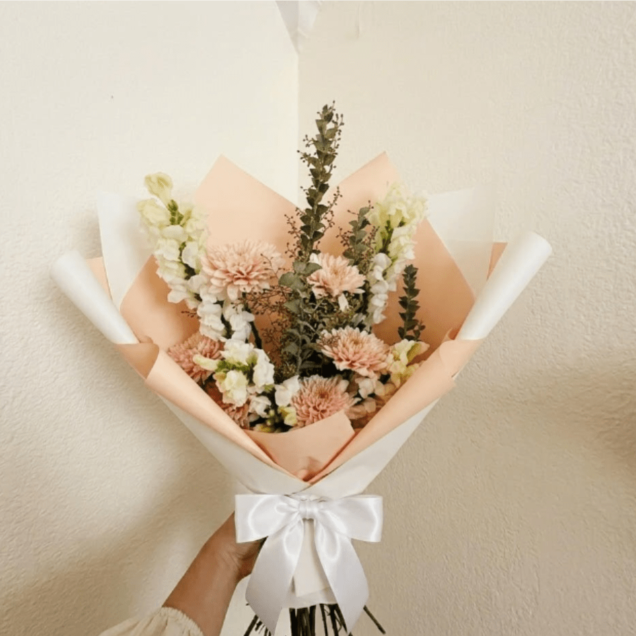 Appreciation - Professional, balanced, and warm—Appreciation is a sophisticated way to say "thank you" to a colleague or client. Peach mums and white snapdragons combine for a look that is both stylish and heartfelt.  This seasonal bouquet features:  Peach Mums  White Snapdragons  Silvery Gunni Eucalyptus  Garden Greens   Presentation: Expertly wrapped in our signature textured paper and tied with satin ribbon. Prefer a vase? Add one to your cart to complete the look.  Personal Touch: We’ll include a custom card message with every order. You’ll be able to write your message at checkout.  Please Note: All flowers are subject to seasonal availability. If a specific bloom isn’t available, our designers will thoughtfully substitute with flowers in a similar shape, style, and color.  Standard size shown. Vase upgrade is optional.   Floral Care Guide  Your arrangement arrives in our signature "double wrap" and is nestled in a protective box. While the stems are secured with a wet wrap for transit they are ready for a full drink!   Unpack: Gently lift the bouquet from the box. Remove the plastic bag and wet towel from the stems. Trim &amp; Hydrate: Trim 1/2" off stems at an angle and place in a clean vase with cool water. Refreshed: Change water daily for a long-lasting bloom. 