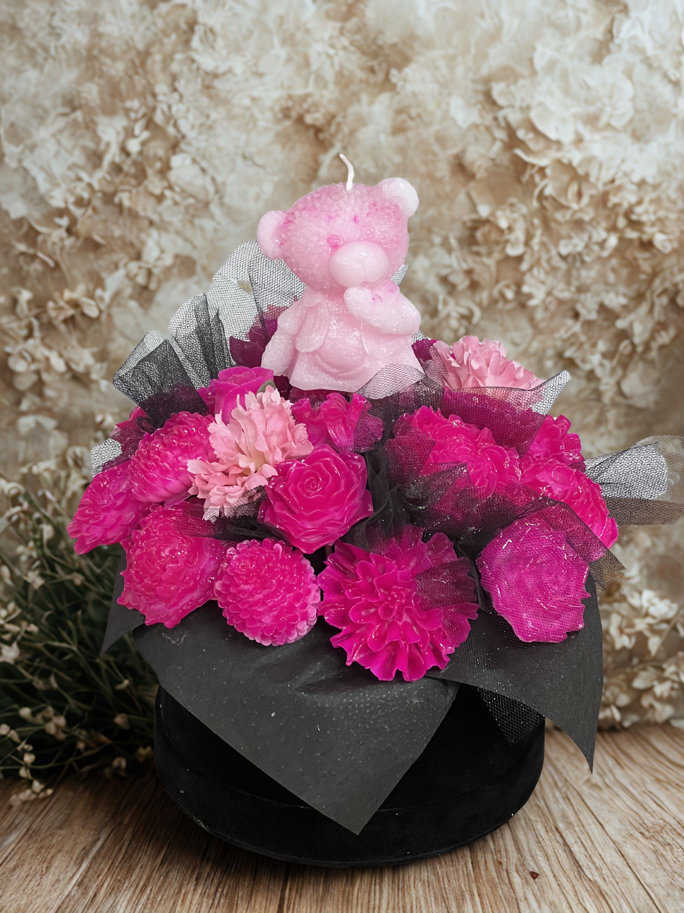 Glowgrove - Vibrant candle flowers in a low black gift box with black mesh accents and a pink bear candle