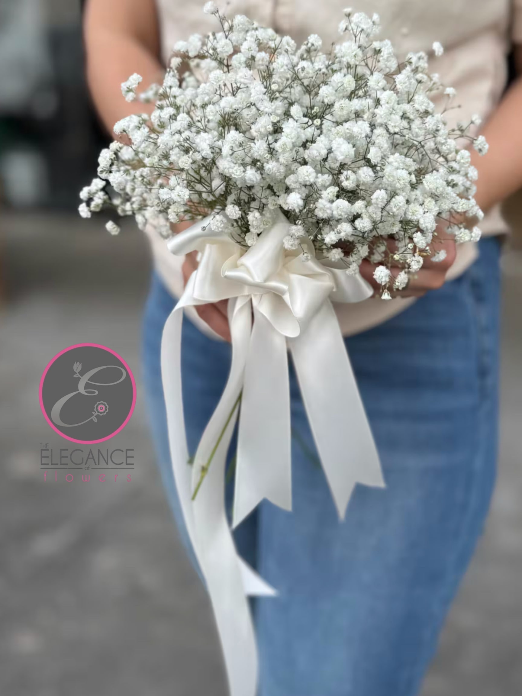 White baby's breath bouquet tied with a satin ribbon
