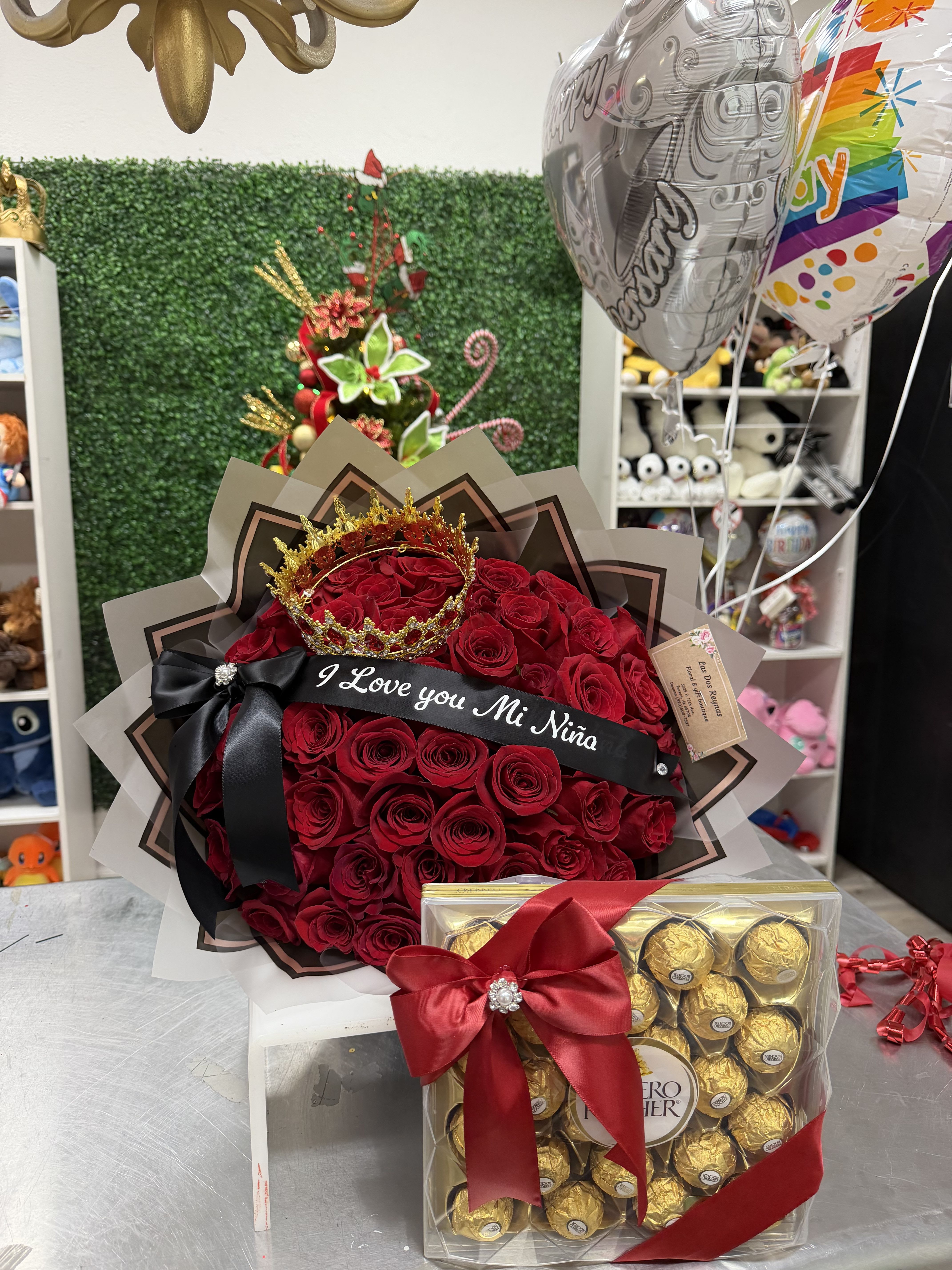 I love you gift set. - 50 long stem Red rose accented with a Red and gold crown finished with a custom satin ribbon parted with a box of chocolate