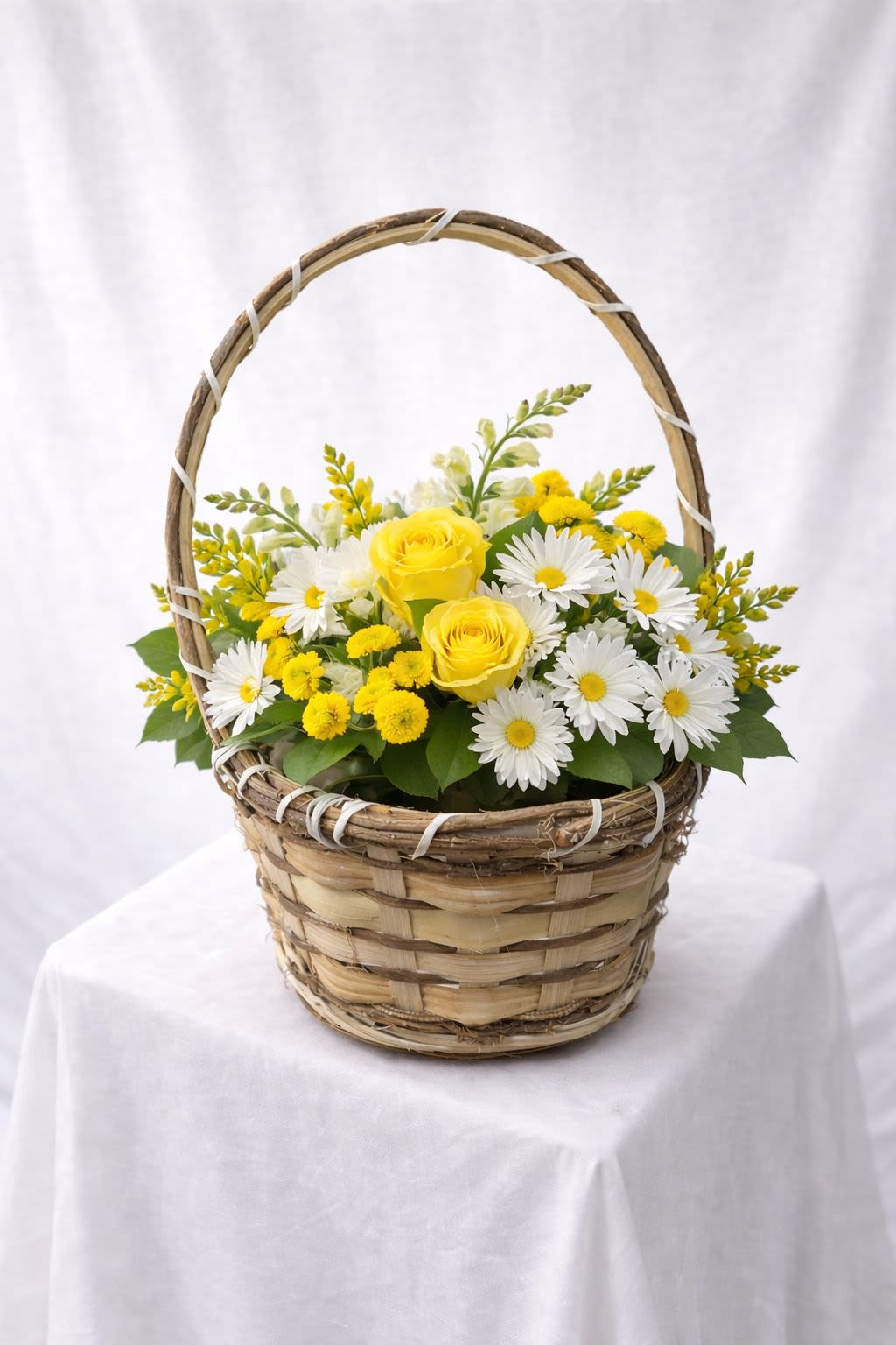 Yellow roses and white daisies in a wicker basket