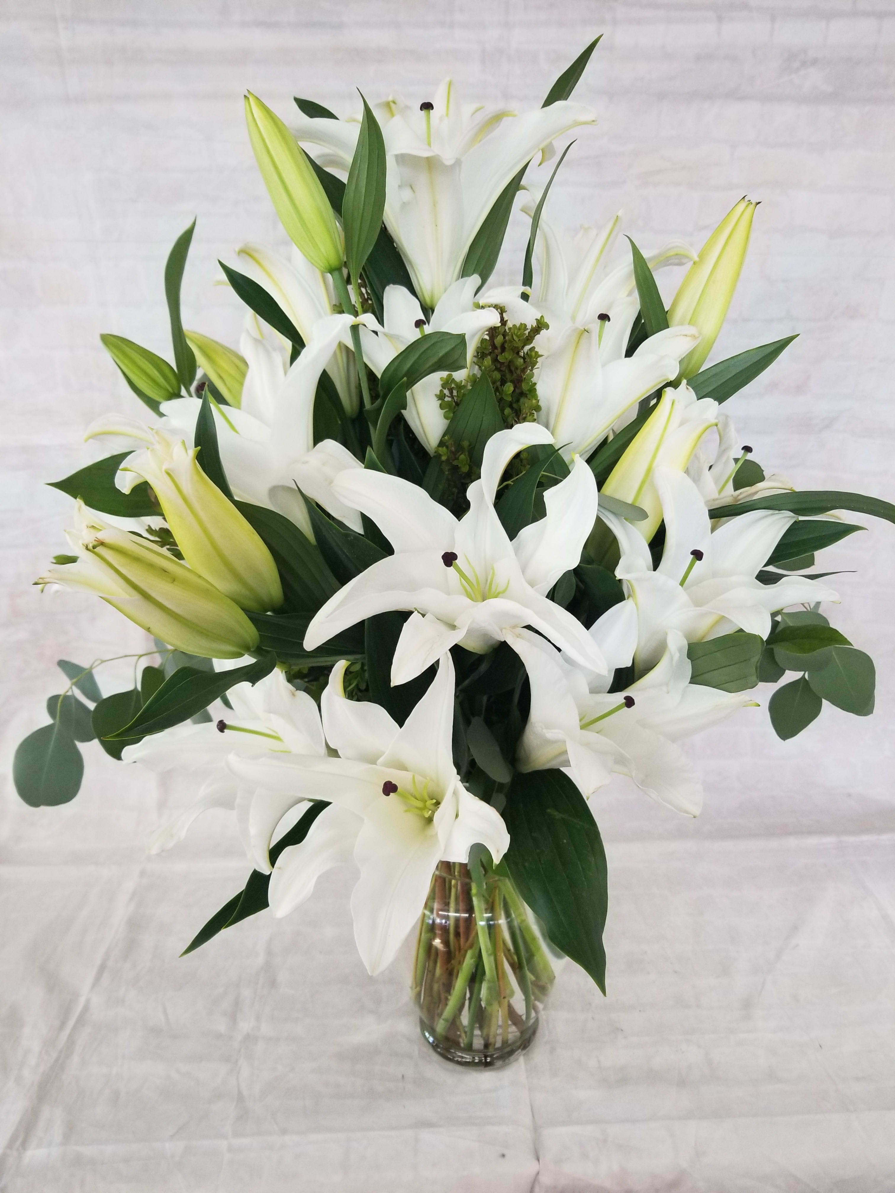 Simply Oriental Lilies - Select this elegant and classic arrangement of 10 white oriental lilies, deluxe will have 15 stems and premium will have 20 stems. 