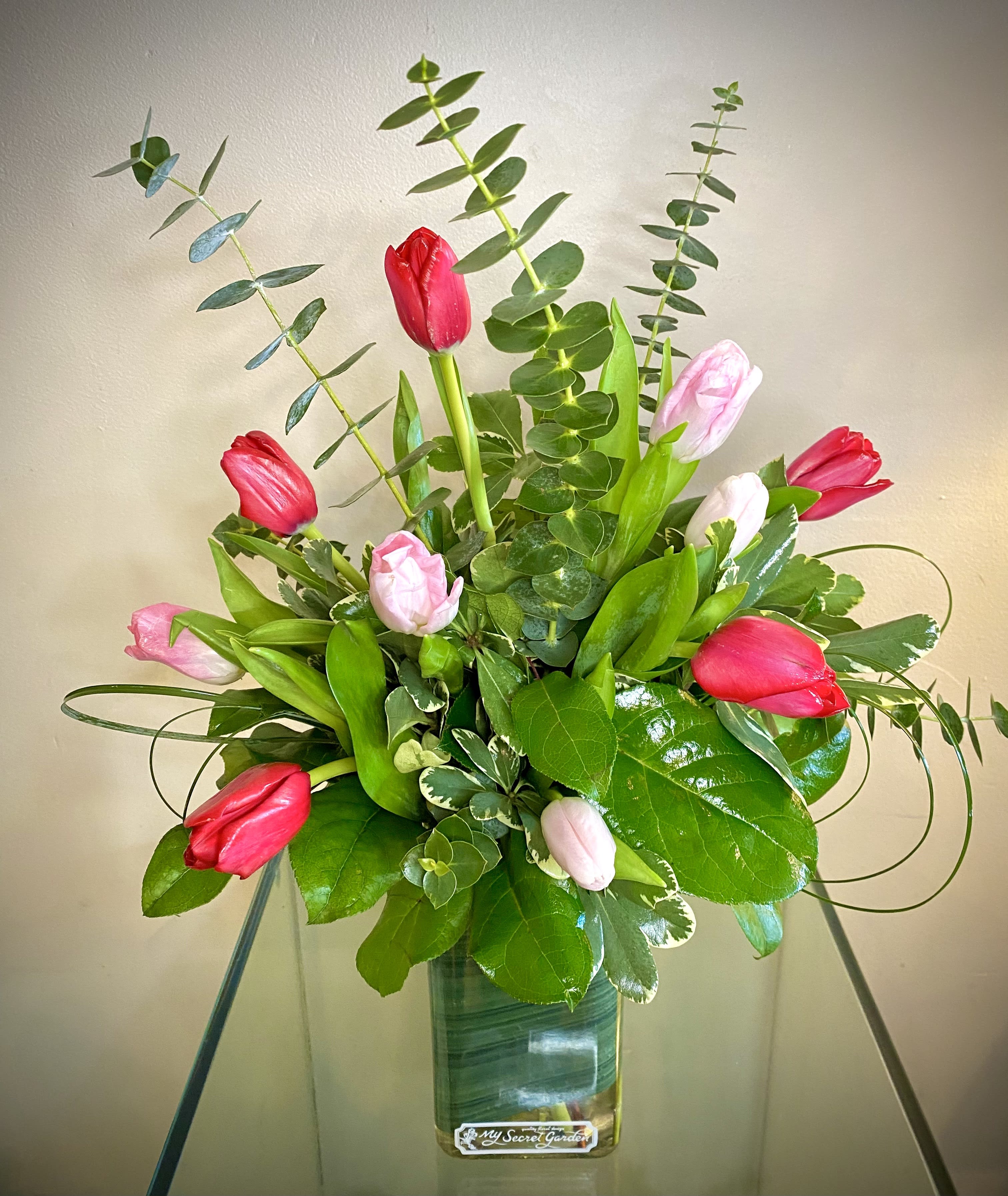 Thrilling Tulips  - Tulips are always a thrill to receive! Gift 10 elegant and simple, fresh tulips in mixed colors, designed in a vase with accent foliage.  The deluxe features 20 Tulips.  ***colors may differ from picture, as we will pick the freshest and most beautiful that we have in stock on the day of your order. If you would like specific colors, please request these colors in the special instructions section of your order form