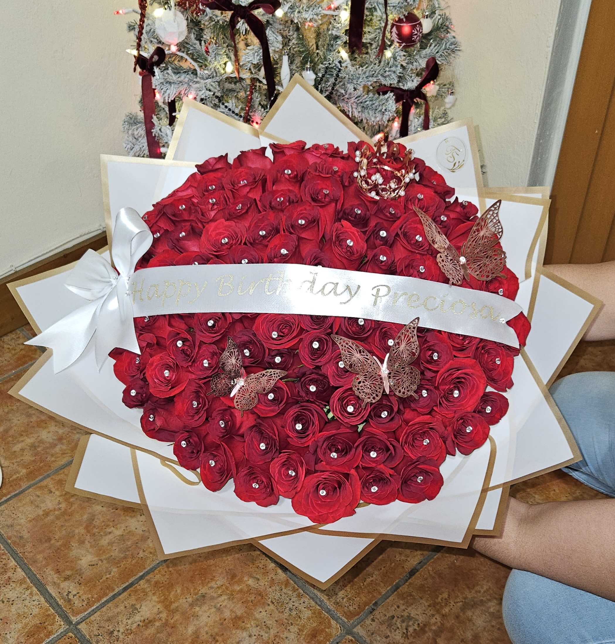 Large red rose bouquet with a birthday ribbon and butterfly decorations