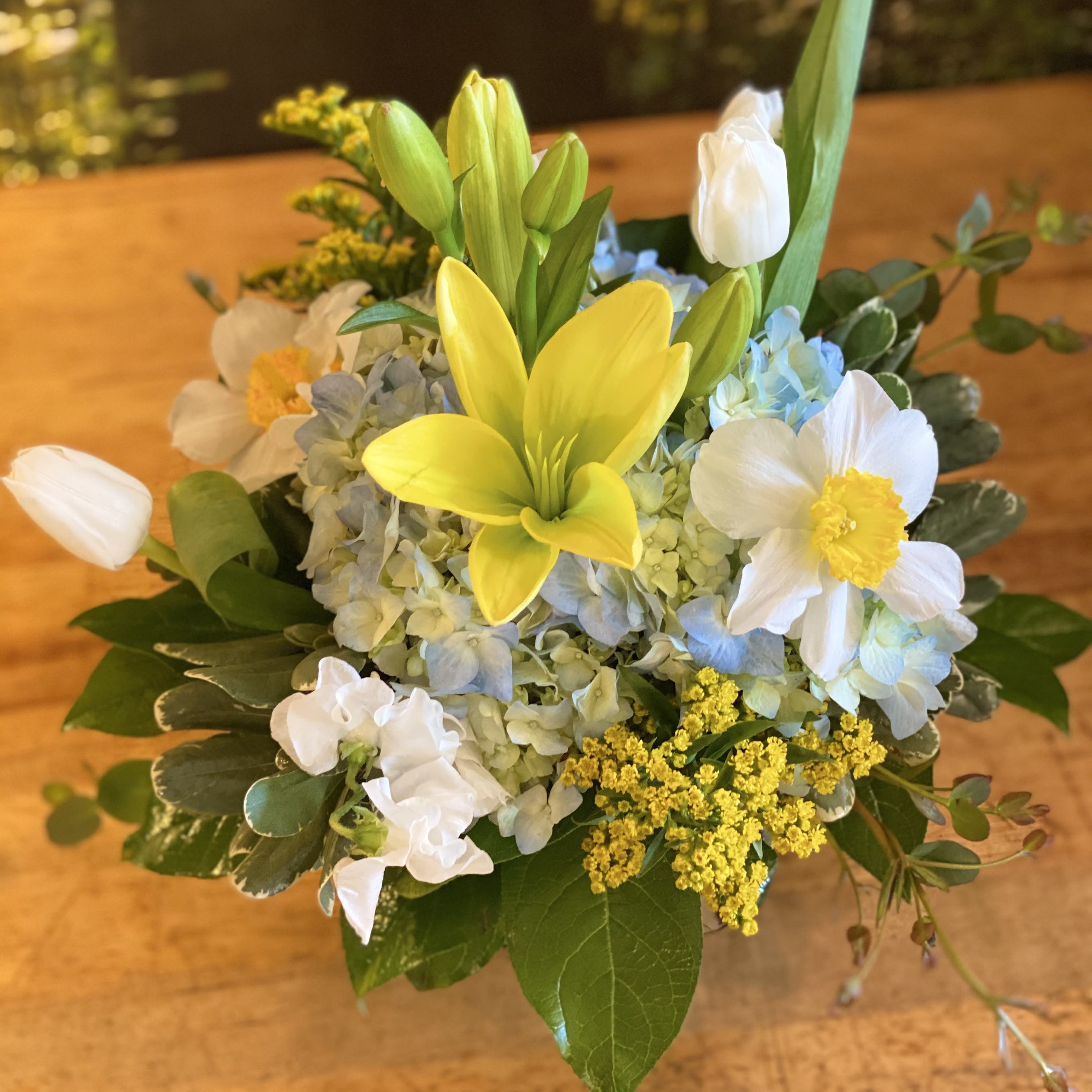 Spring Skies - Soft and sweet, Spring Skies will bring joy to anyone's day! Blue, yellow and white colors presented in flowers of Lilies, stock, hydrangea, tulips and daffodils.  