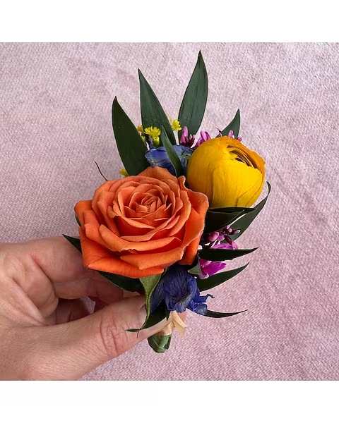 Bright Colors Boutonniere - All of our boutonnieres include multiple blooms with touches of greenery. Each boutonniere is wrapped in a thin tie of silk ribbon and two boutonniere pins are included.