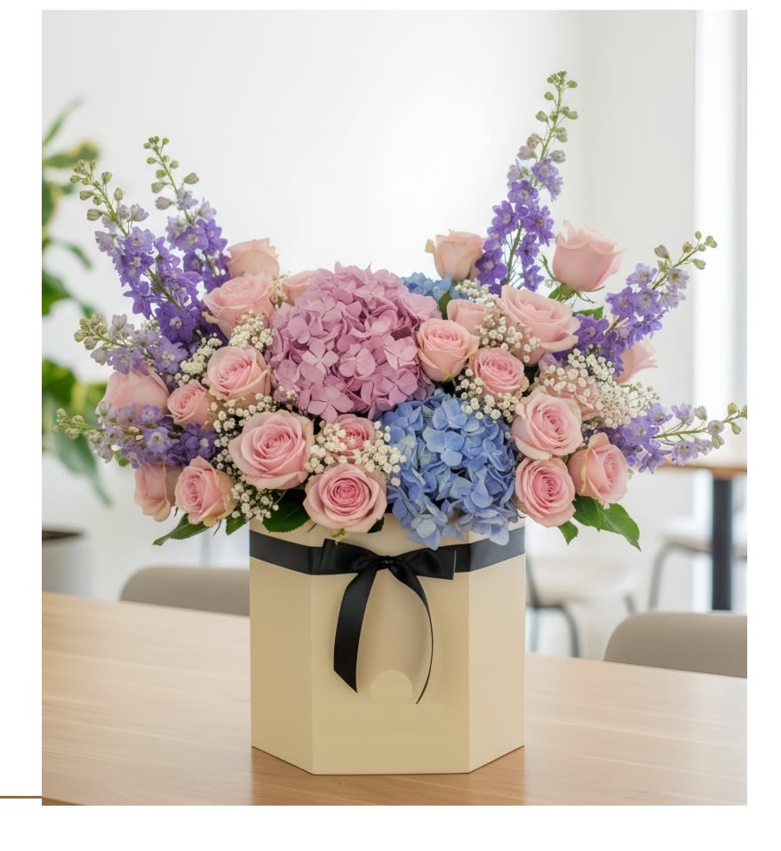 Graceful Harmony round box  - This vibrant one-sided arrangement features soft pink hydrangeas, &amp; vibrant blue hydrangeas, elegant , Pink roses, all beautifully accented with fresh Stock .green fillers and round box,this bouquet brings a burst of warm colors, making it a perfect choice to express love, admiration, and joy.