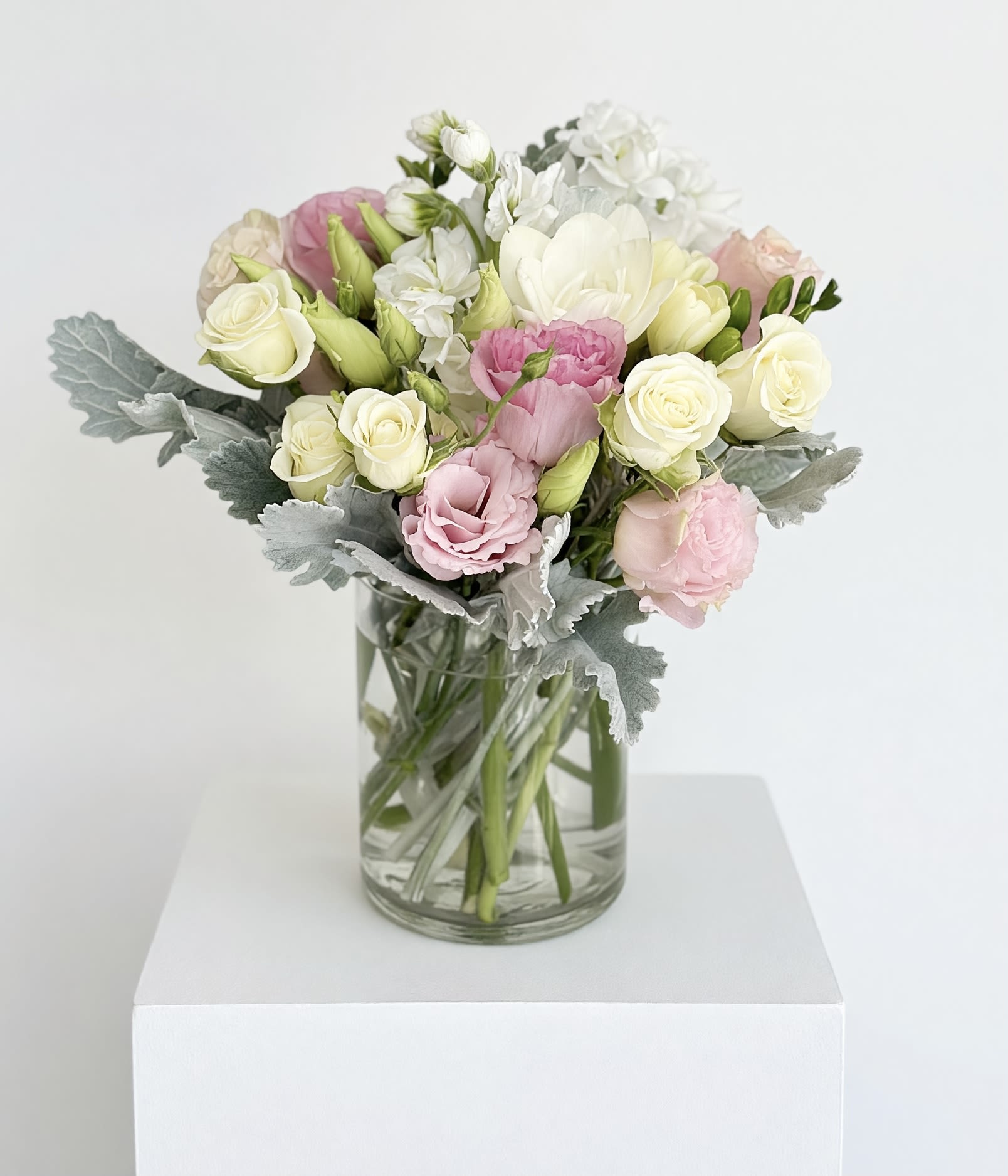 Sweet &amp; Subtle by BloomNation™ - This arrangement includes pink roses, white roses, white spray roses, pink carnations, and dusty miller. Sweet &amp; Subtle by BloomNation™ is the perfect gift for a birthday, thank you, or just because.   APPROXIMATE DIMENSIONS: 9" H X 10" W