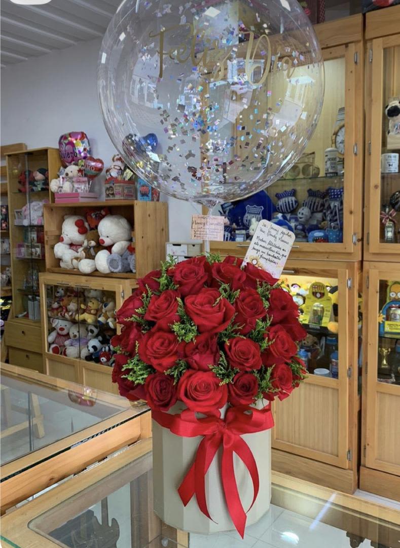 Red rose bouquet in a white box with a clear balloon above it