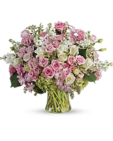 Pink and white rose bouquet in a clear glass vase