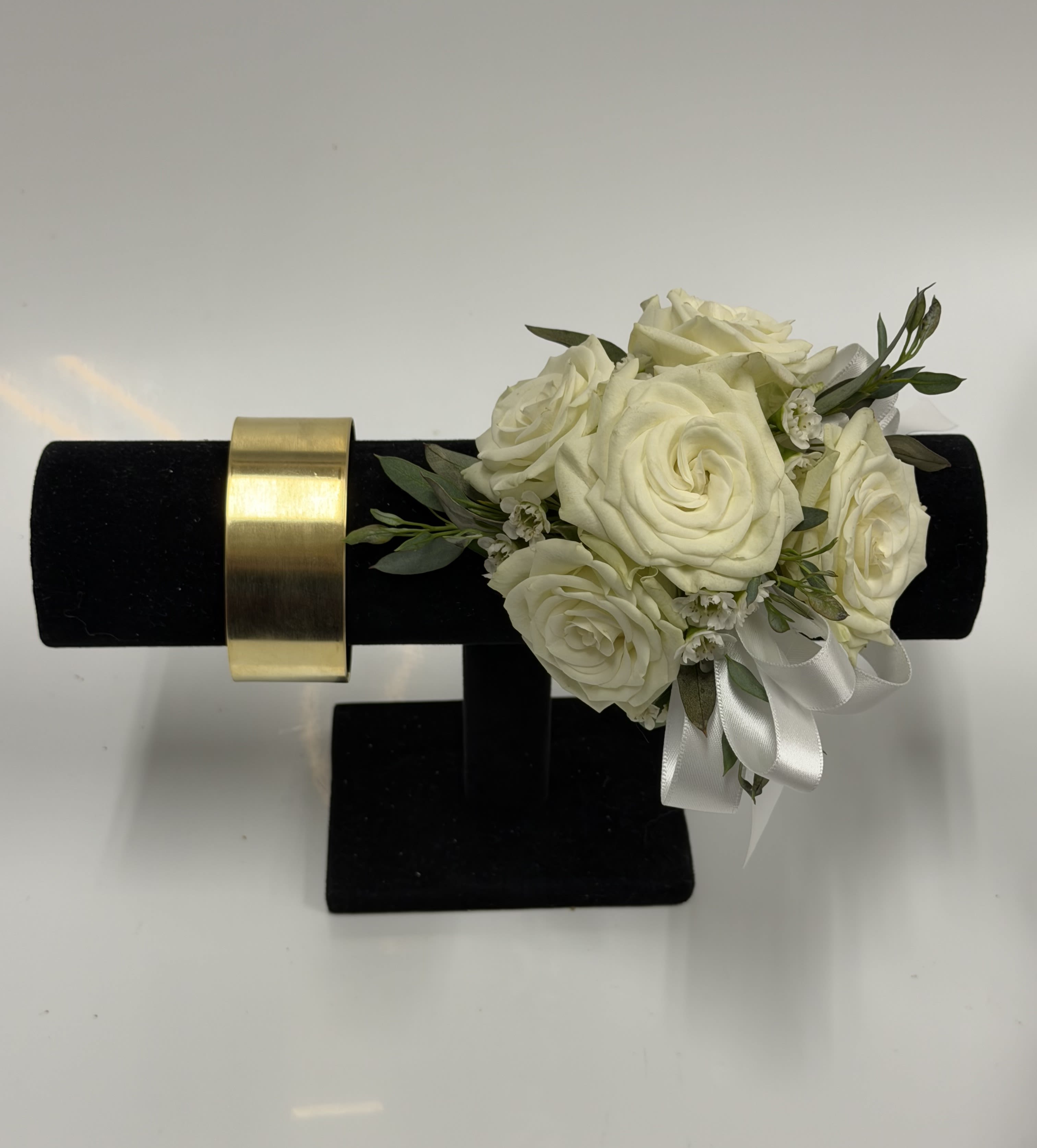 White Spray Rose Corsage with Gold Cuff Wristlet - White spray roses, sheer ribbon, gold cuff wristlet, white or light pink filler flower on a bed of greenery. Ribbon color can be customized; please specify in the pick-up note section.