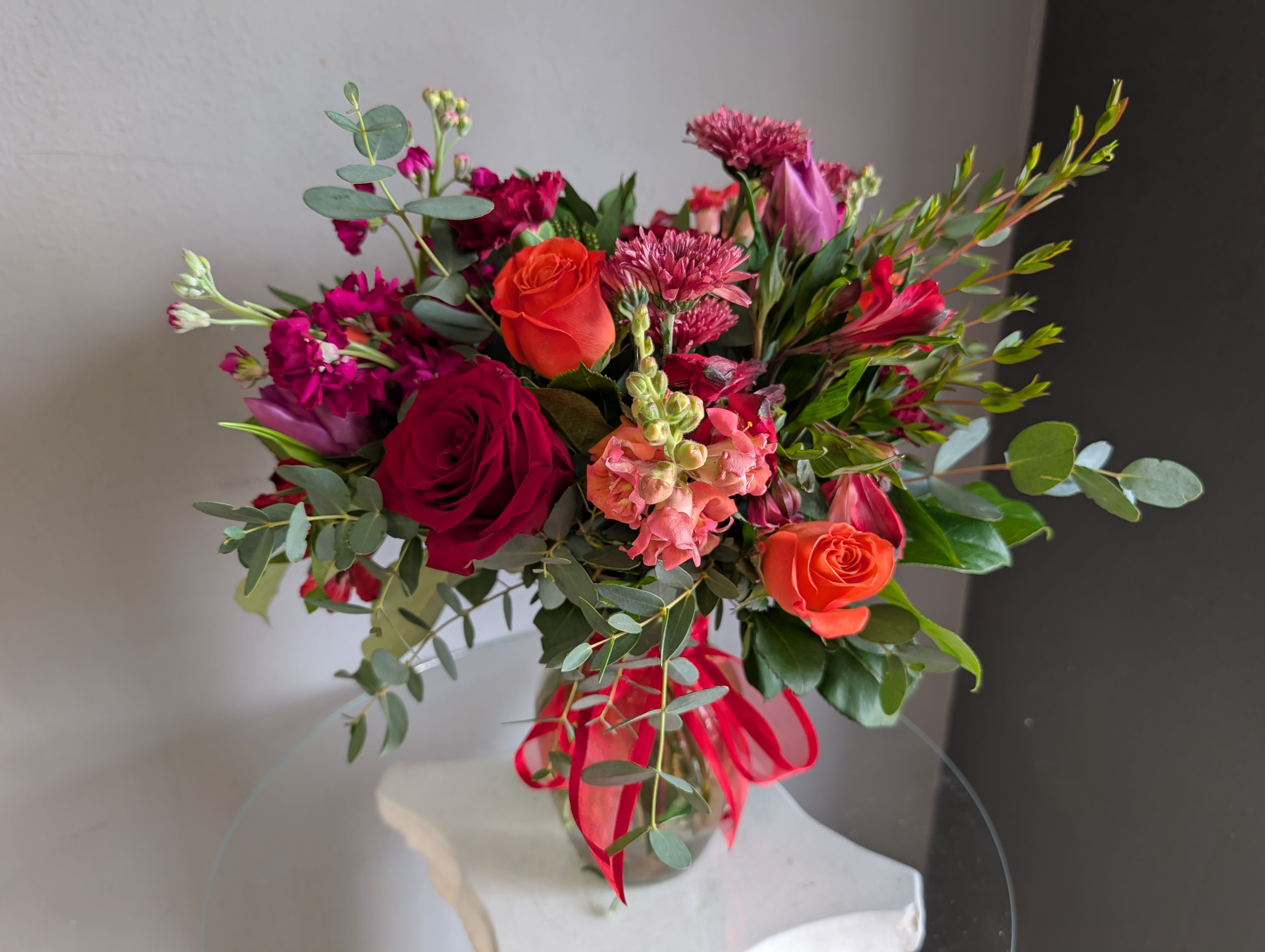 #707 Designer's Choice Vase Arrangement - This beautiful flower arrangement of fresh mixed seasonal blooms is made by local designers in the heart Orange California. Hand crafted and perfect for every occasion, from birthdays and new babies to sympathy and just because. The best choice to show you are thinking of that special someone. Can be sent as a local delivery or in-store pickup. This is an original, one of a kind arrangement. Order now before it's too late!  All upgrades are applied at the designer’s discretion and fulfilled to value using the freshest seasonal and/or premium flowers available. Container upgrades may be included when possible; otherwise, value is reflected in the floral selection while maintaining the original design style.   All upgrades are applied at the designer’s discretion and fulfilled to value using the freshest seasonal and/or premium flowers available. Container upgrades may be included when possible; otherwise, value is reflected in the floral selection while maintaining the original design style.  