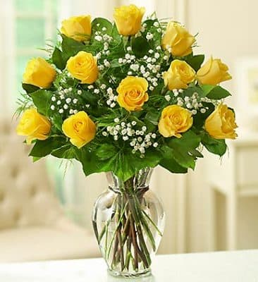 Dozen Yellow Roses Arranged  - Twelve gorgeous yellow roses in arranged with your choice of basic greenery or fancy filler and arranged in a clear glass vase Different colours of roses are available upon request. 