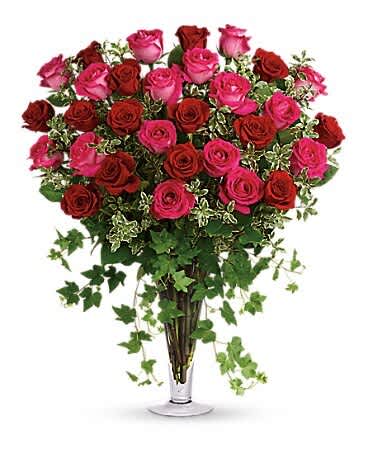 Bouquet of pink and red roses in a clear glass vase