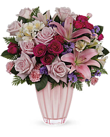 Pink and white mixed flower bouquet in a clear vase